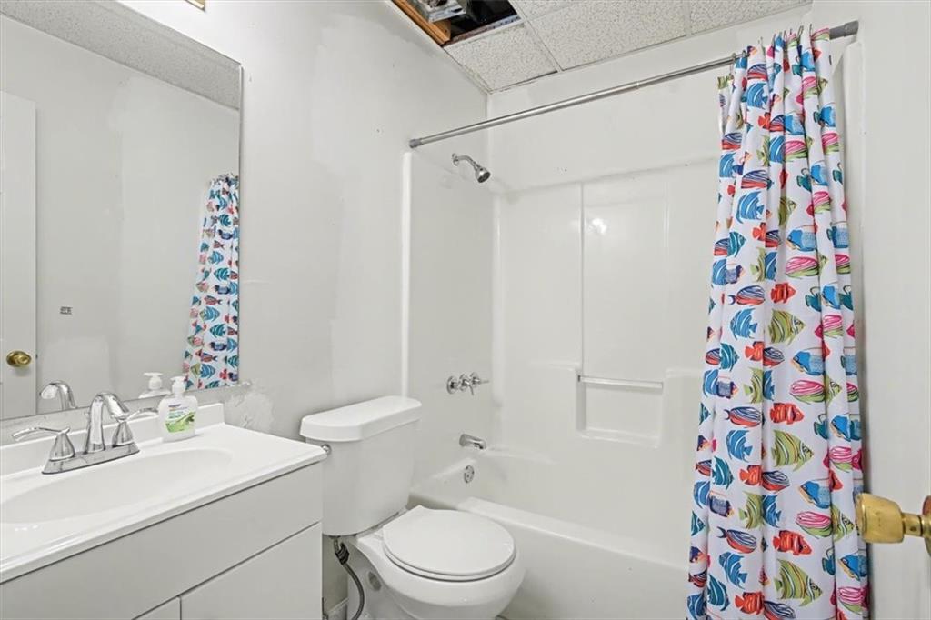 5 Ridgewood Drive Cartersville, GA 30120 - Photo 32 of 46 a bathroom with a sink a toilet and shower curtain