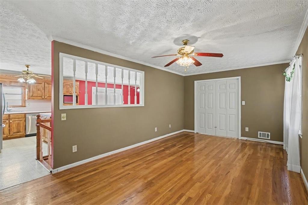 5 Ridgewood Drive Cartersville, GA 30120 - Photo 4 of 46 a view of an empty room with window and a chandelier fan