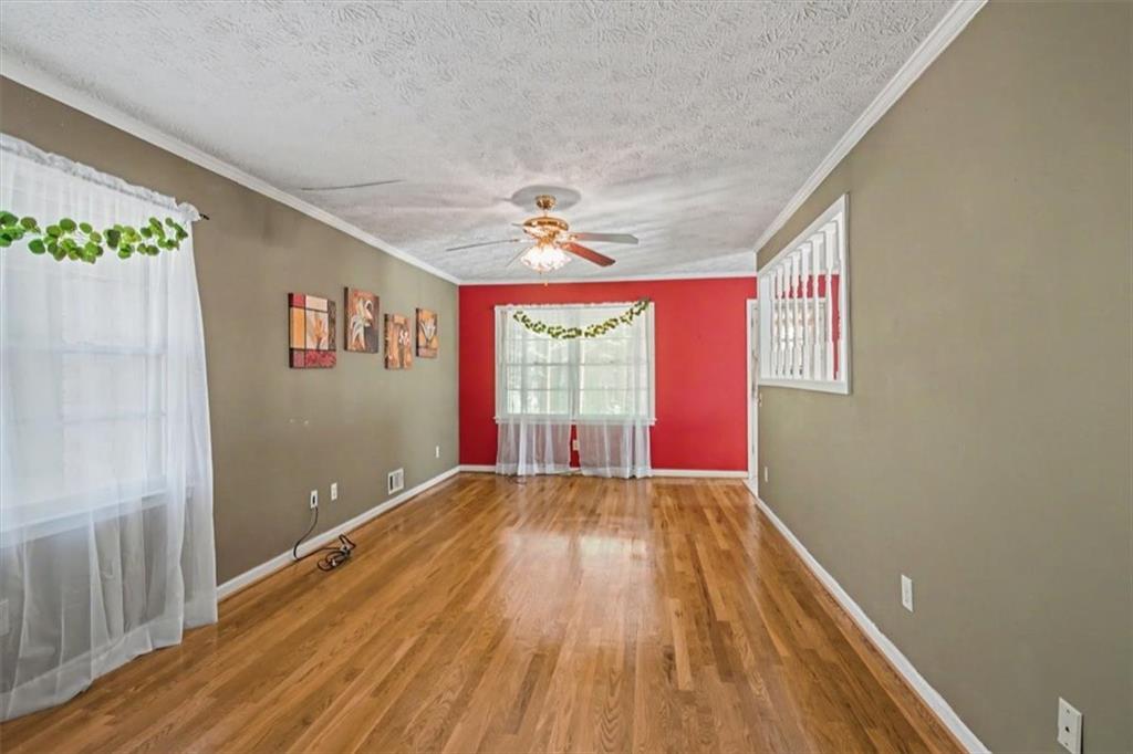 5 Ridgewood Drive Cartersville, GA 30120 - Photo 5 of 46 a view of an empty room with wooden floor and a window