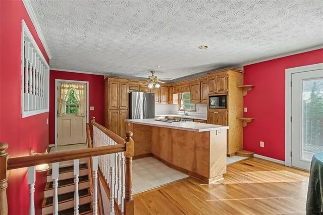 a kitchen with stainless steel appliances granite countertop a stove and cabinets