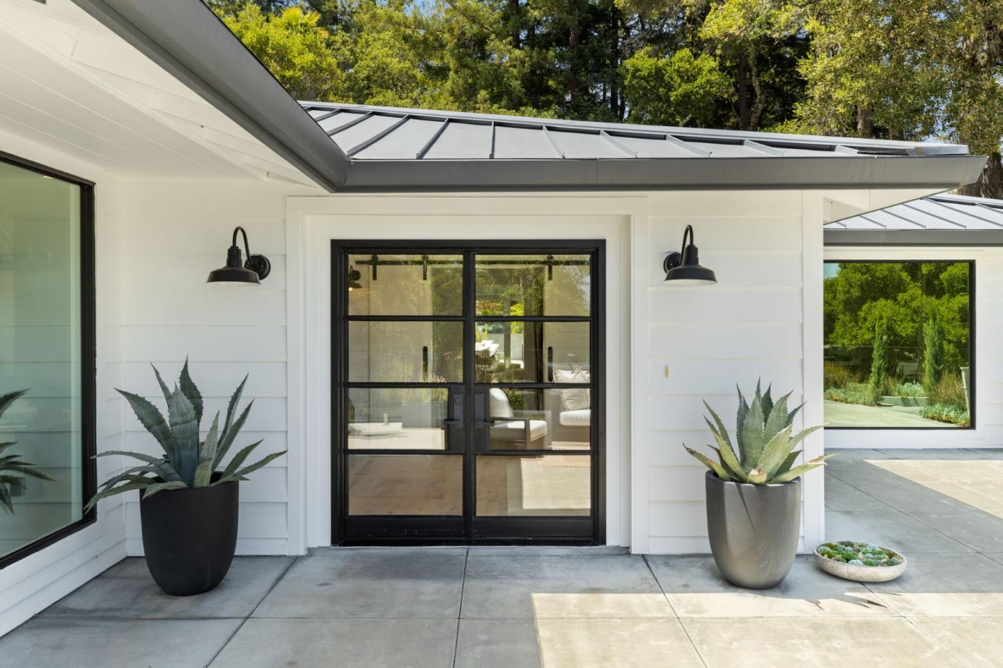 595 Summit Spring Road Woodside, CA 94062 - Photo 3 of 56 a potted plant sitting in front of a glass door with a potted plant on the side