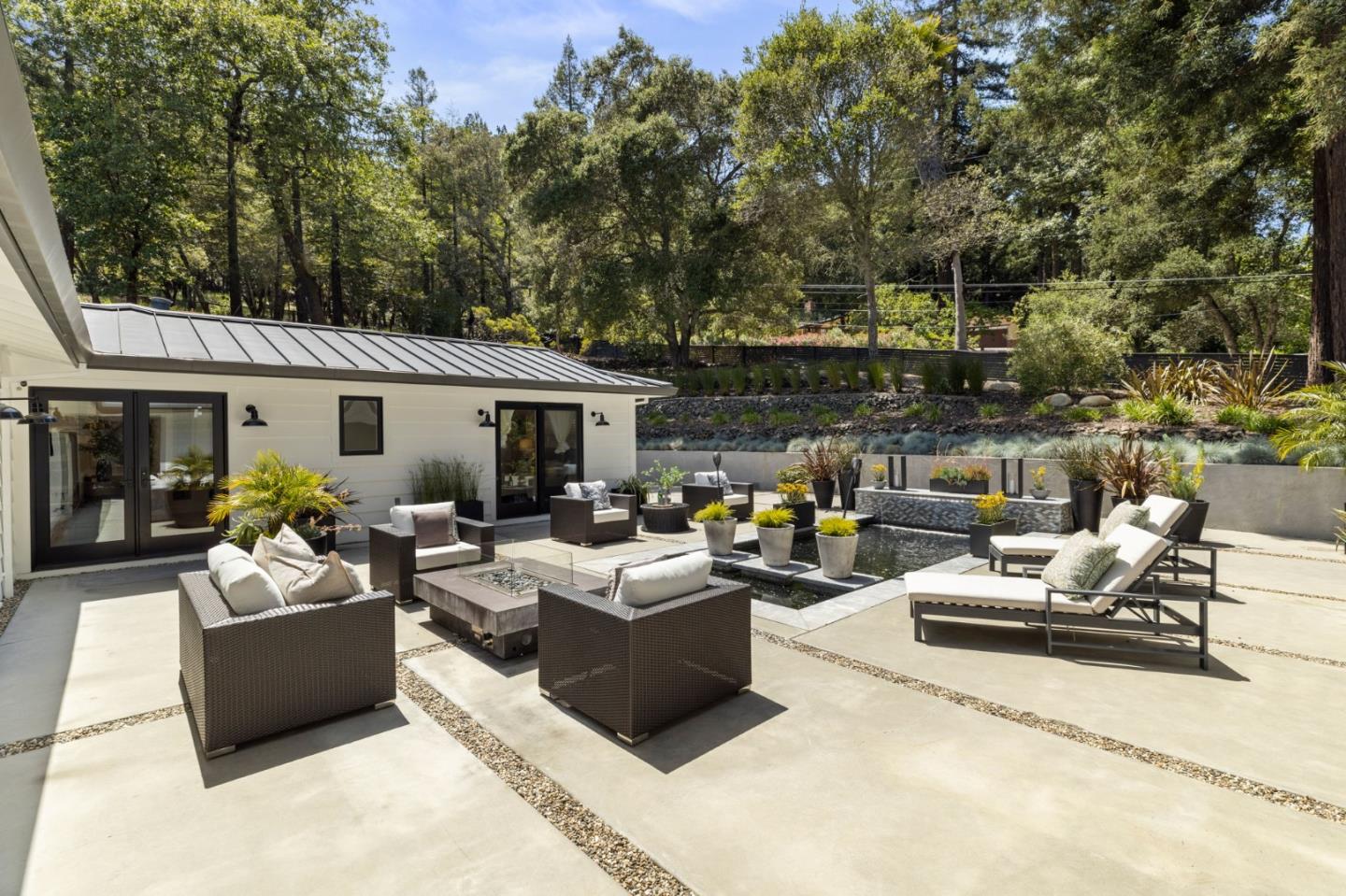 595 Summit Spring Road Woodside, CA 94062 - Photo 45 of 56 a view of a patio with couches and chairs with potted plants