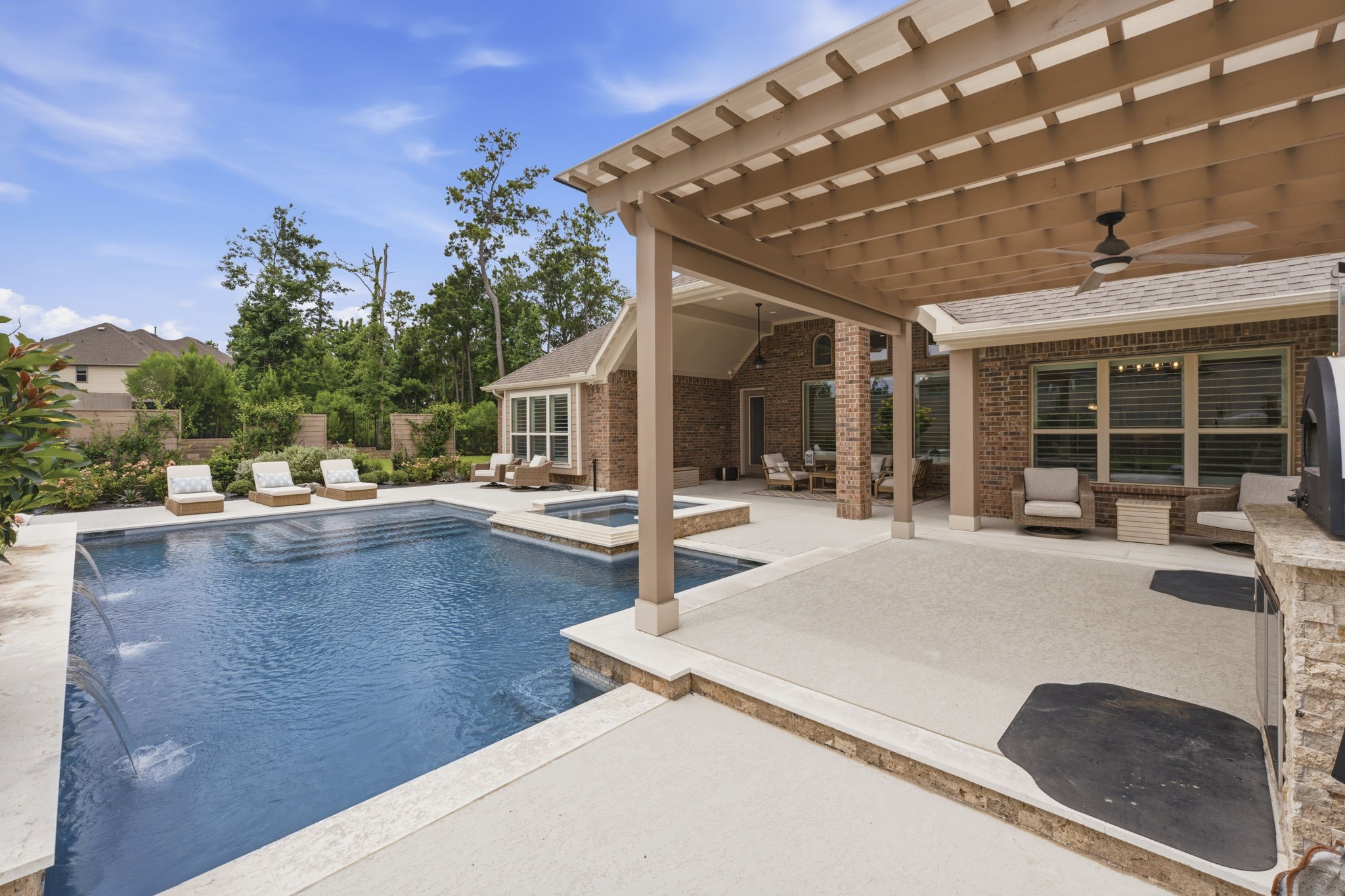 14012 Beartooth Bend Trail Conroe, TX 77384 - Photo 44 of 50 With ample room for outdoor seating and dining, the covered patio and outdoor kitchen seamlessly combine to extend the living space and create the perfect setting for entertaining family and friends.