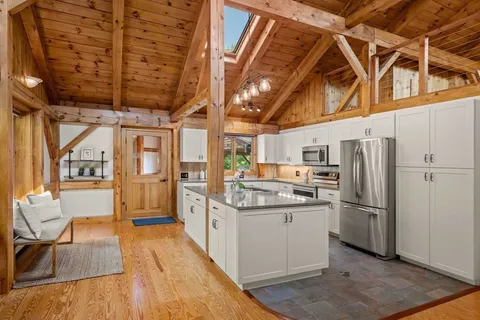 a kitchen with stainless steel appliances granite countertop a refrigerator and a stove
