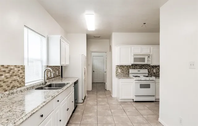 a kitchen with a sink stove and refrigerator