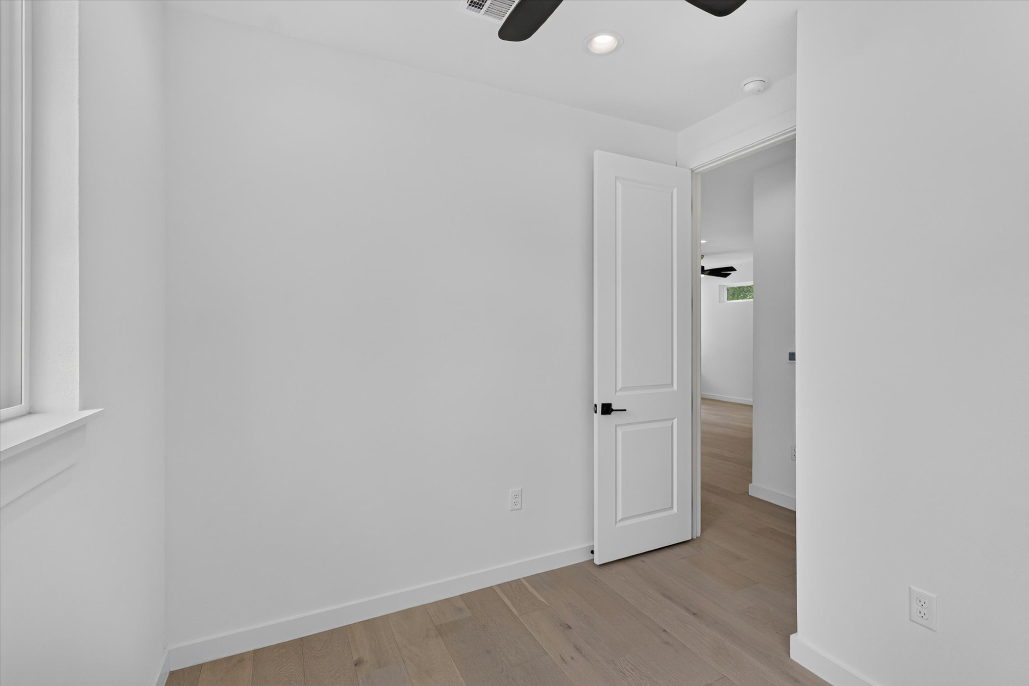 5305 Ledesma Road, Unit 1 Austin, TX 78721 - Photo 12 of 29 A well-lit, neutral room with light wood flooring offers a serene and adaptable living space.