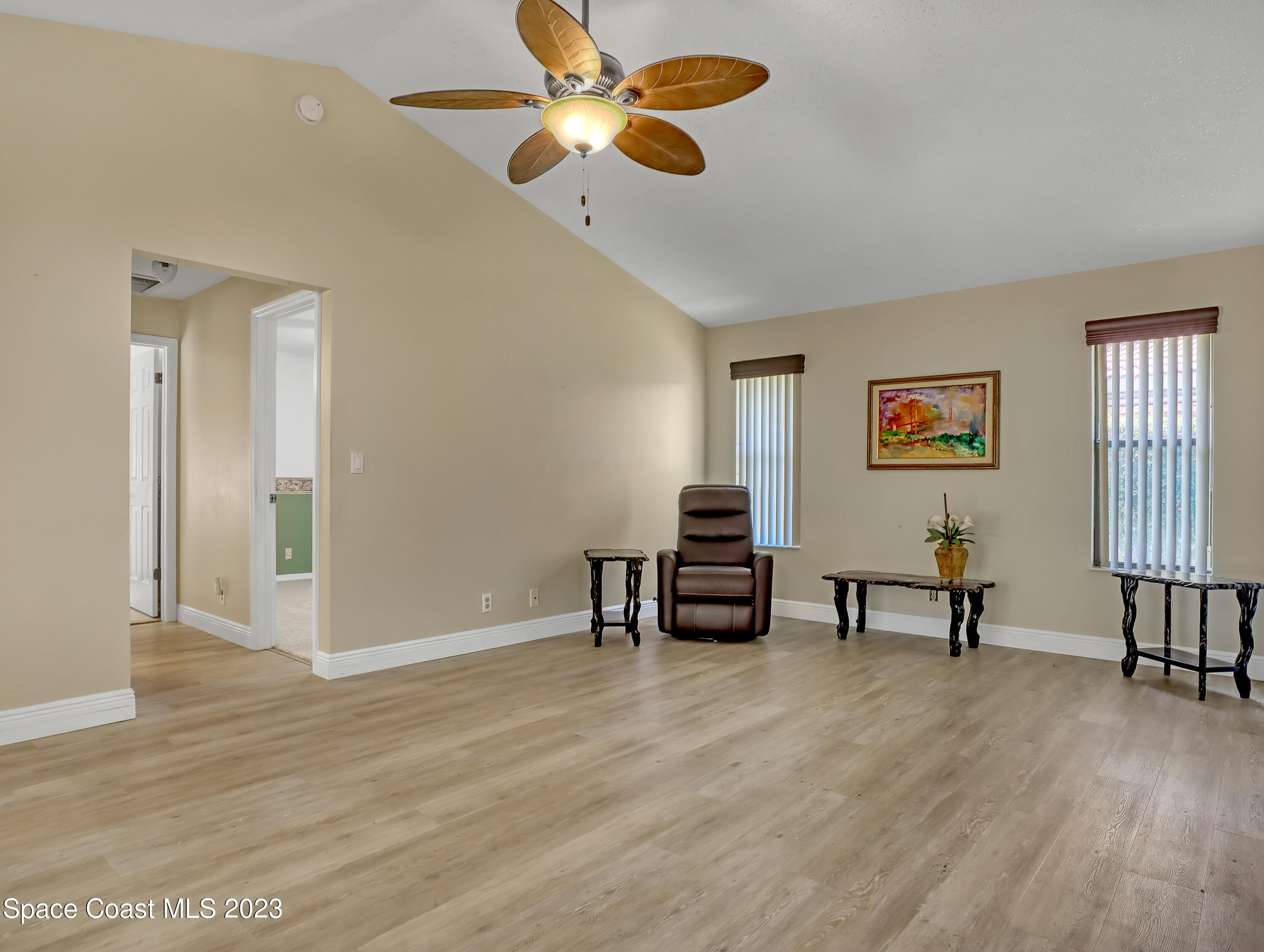 705 Casa Grande Drive Melbourne, FL 32940 - Photo 13 of 32 a view of a livingroom with furniture and wooden floor