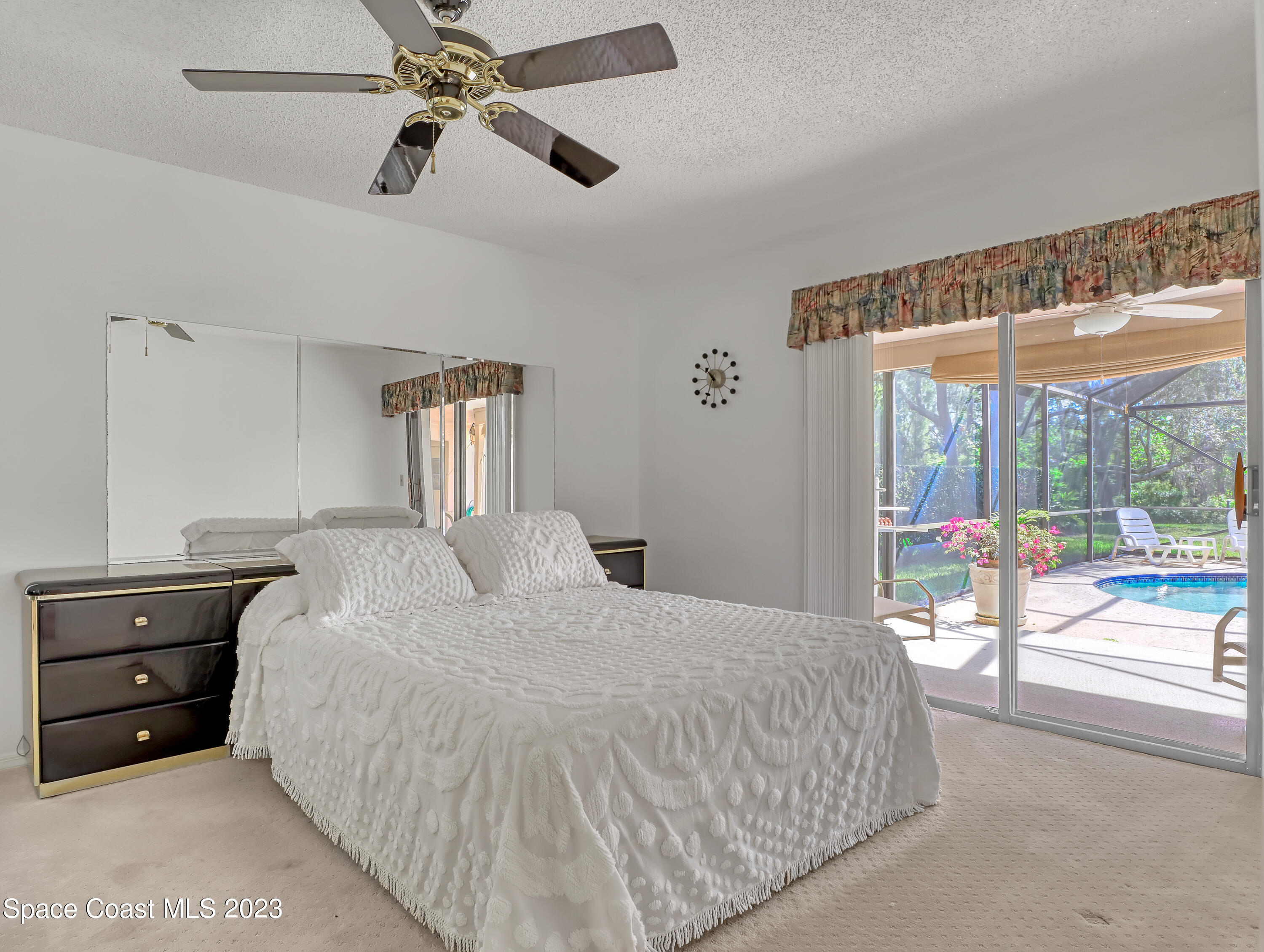 705 Casa Grande Drive Melbourne, FL 32940 - Photo 16 of 32 a bedroom with a bed and a large window