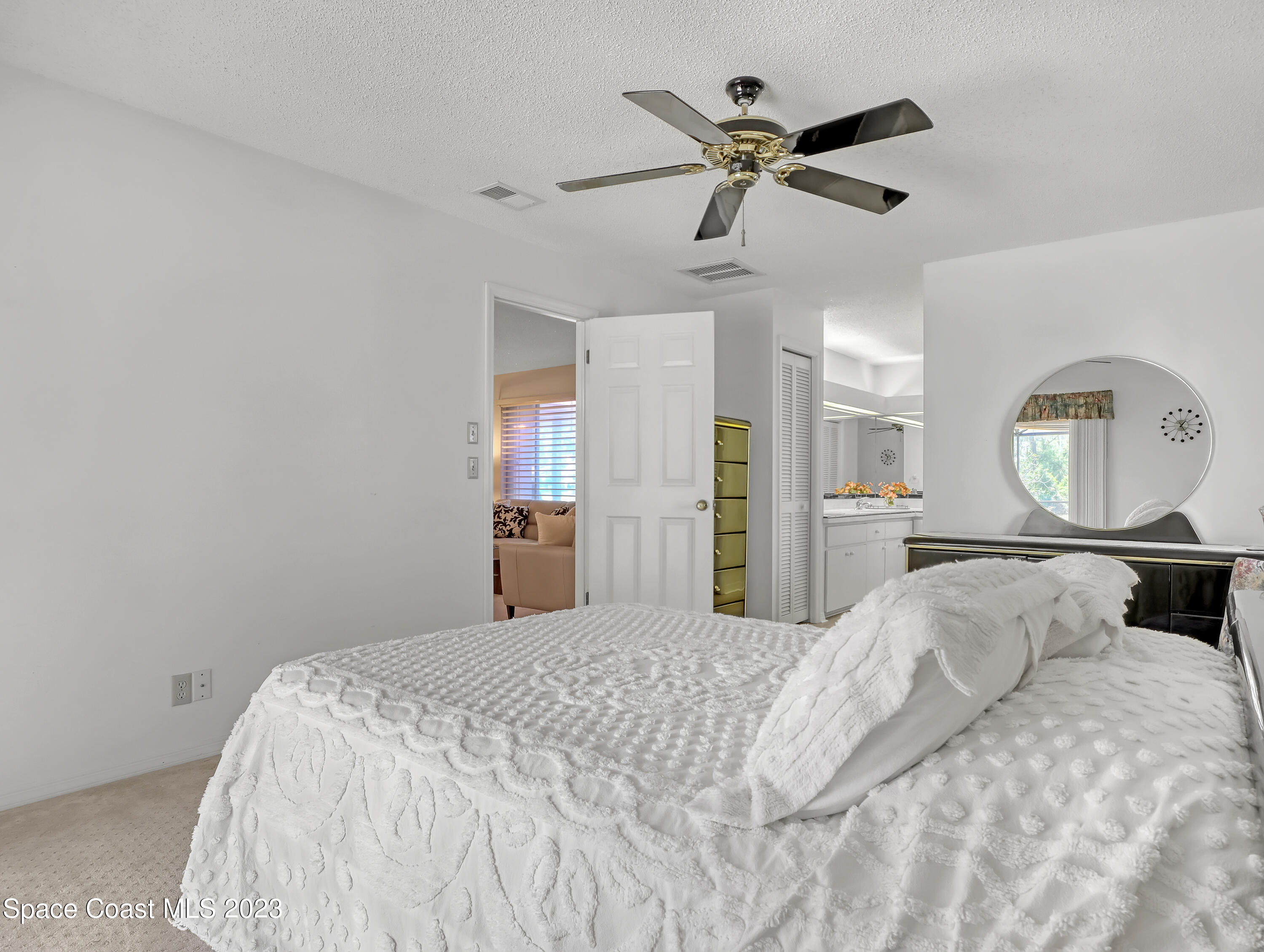 705 Casa Grande Drive Melbourne, FL 32940 - Photo 17 of 32 a bedroom with a large bed and a window