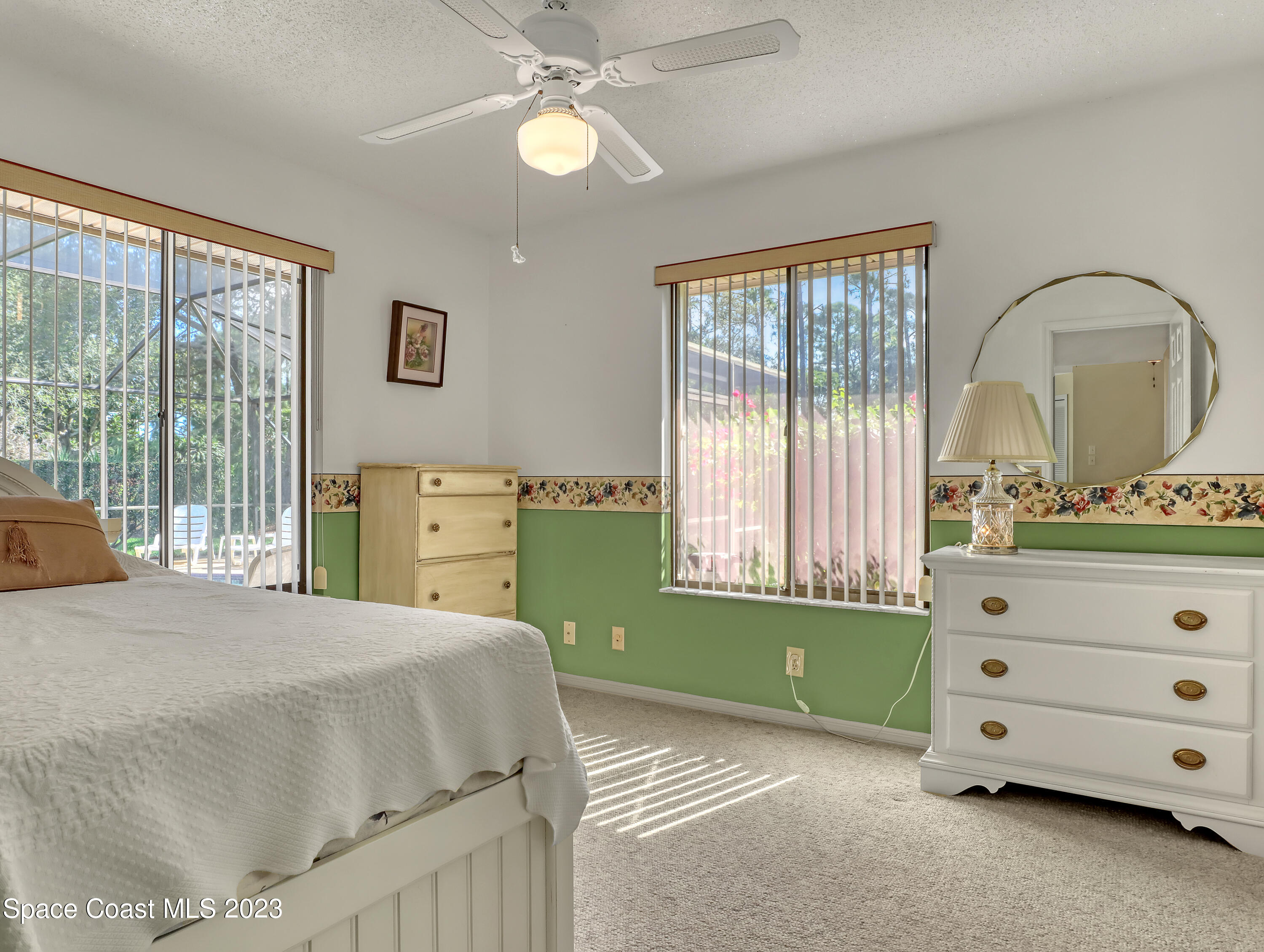705 Casa Grande Drive Melbourne, FL 32940 - Photo 20 of 32 a bedroom with a bed and a window
