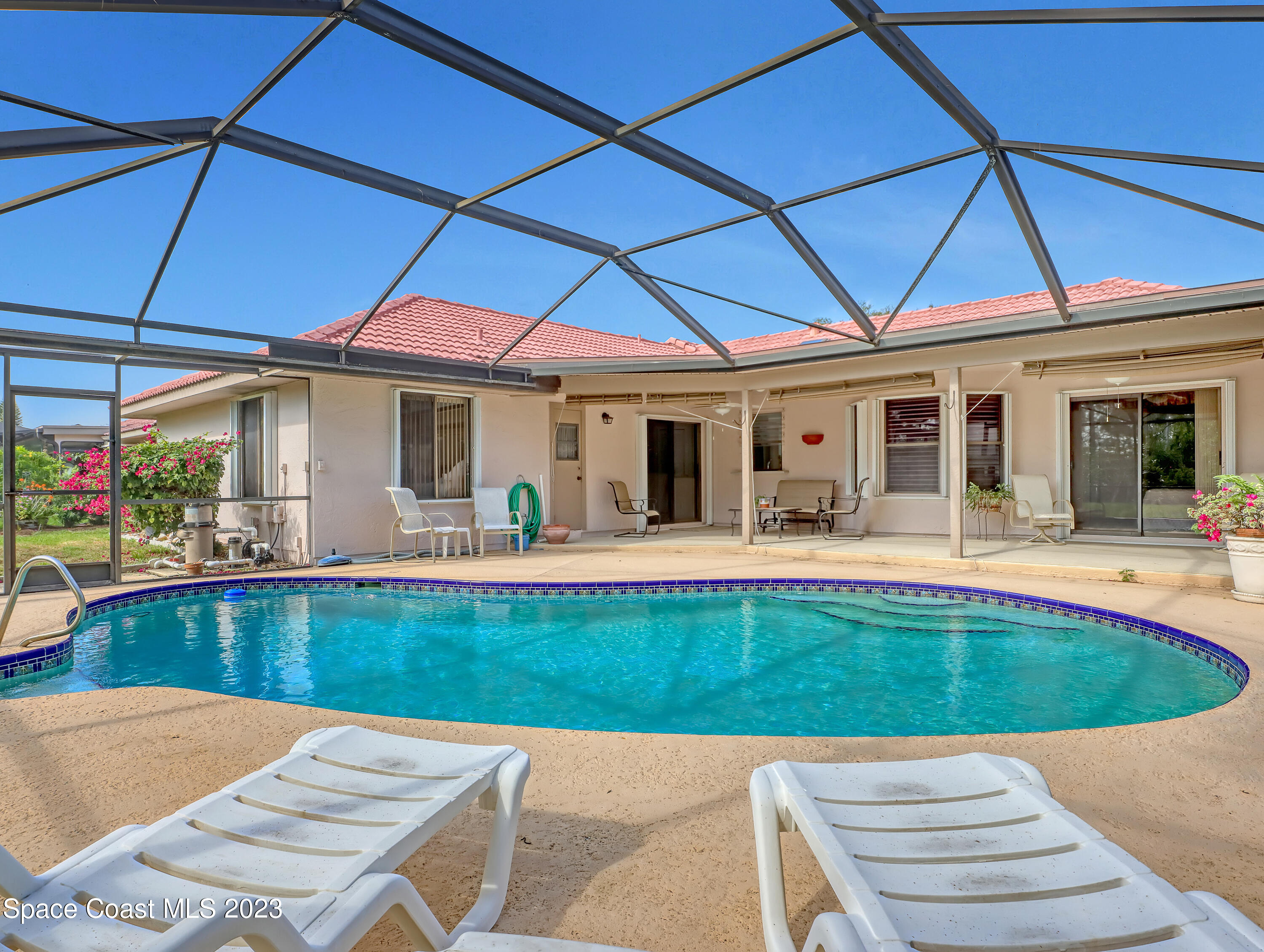 705 Casa Grande Drive Melbourne, FL 32940 - Photo 2 of 32 a view of a patio with swimming pool table and chairs
