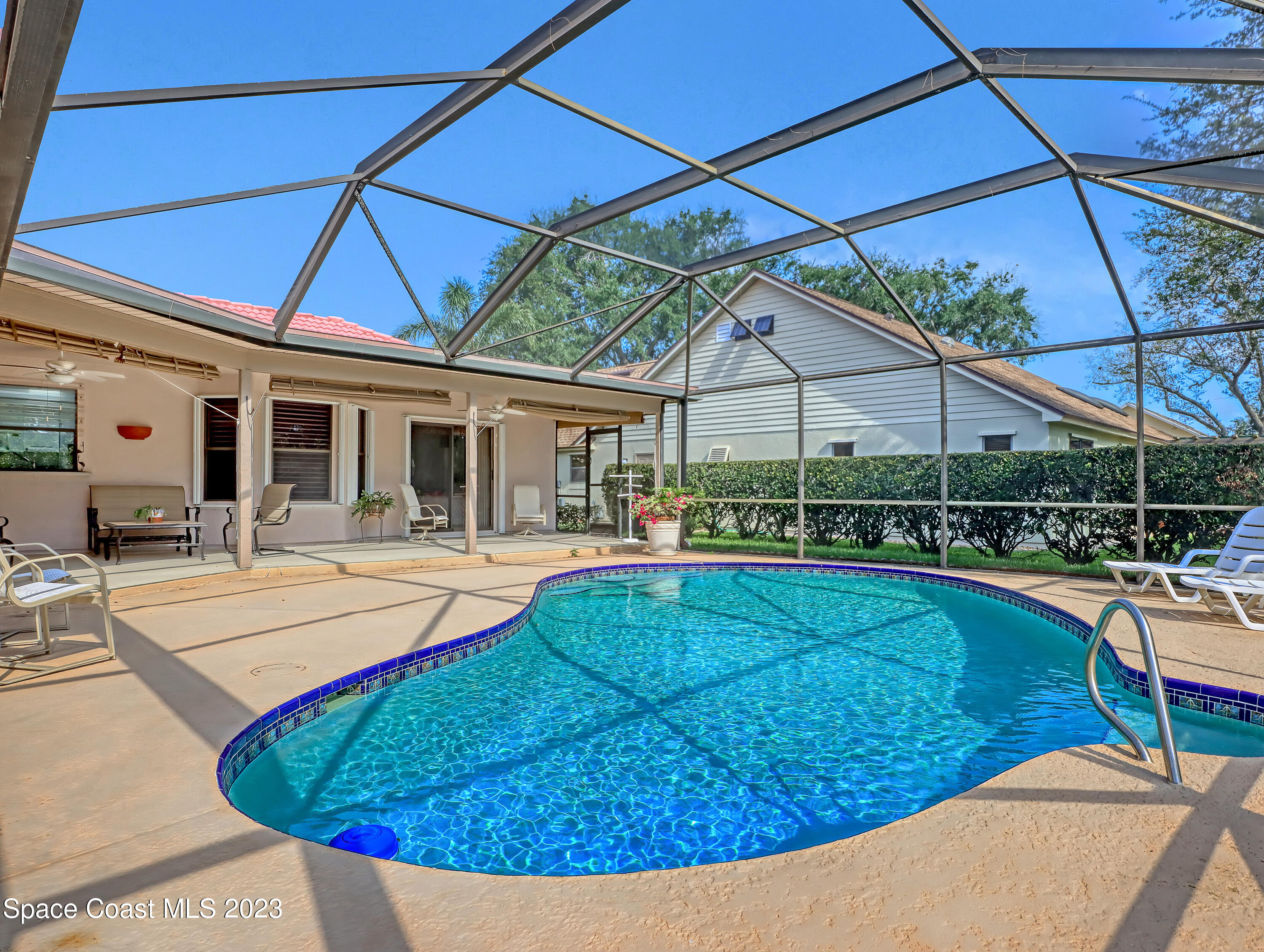 705 Casa Grande Drive Melbourne, FL 32940 - Photo 24 of 32 a view of a house with swimming pool and porch