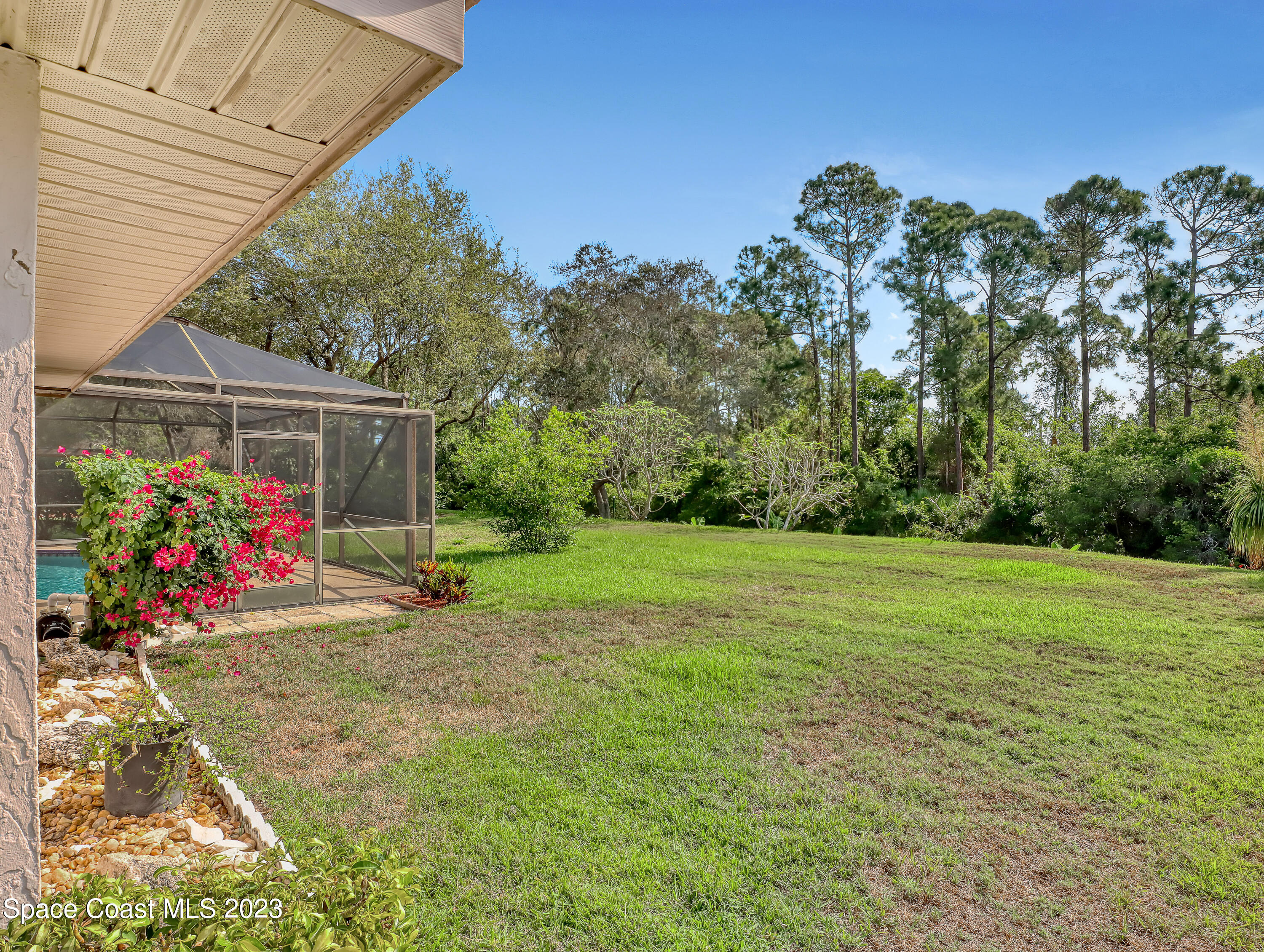 705 Casa Grande Drive Melbourne, FL 32940 - Photo 26 of 32 a view of a backyard with a garden and entertaining space