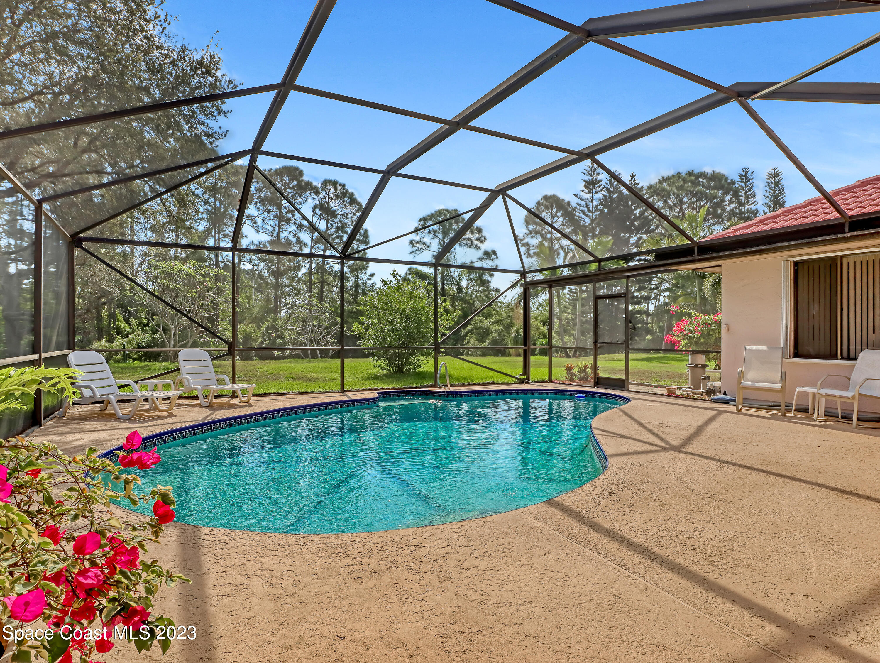 705 Casa Grande Drive Melbourne, FL 32940 - Photo 3 of 32 a view of swimming pool with a yard and sitting area