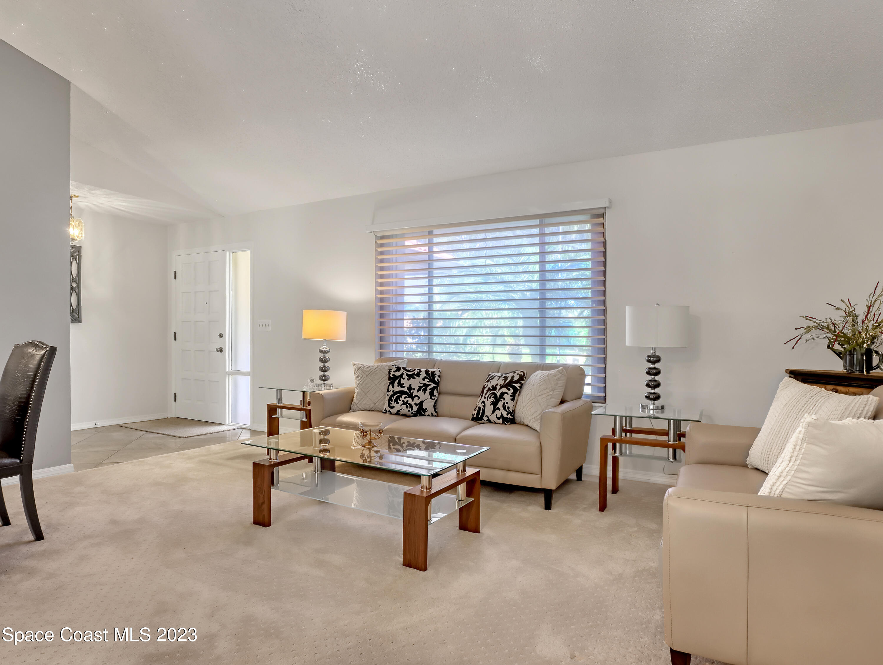 705 Casa Grande Drive Melbourne, FL 32940 - Photo 6 of 32 a living room with furniture and a large window
