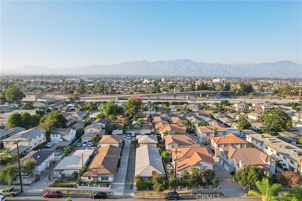 an aerial view of residential houses with city view