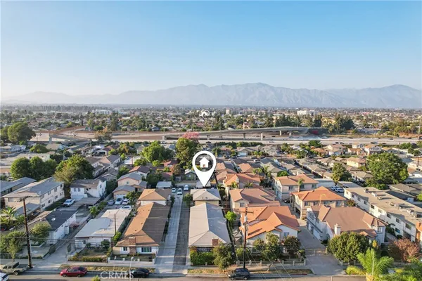 an aerial view of residential houses with outdoor space and street view