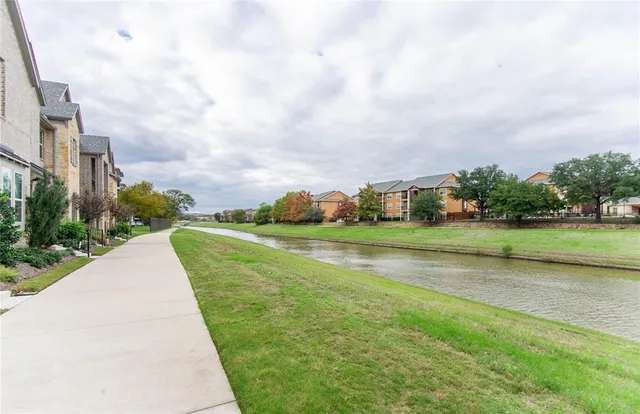 a view of building with river in front of it