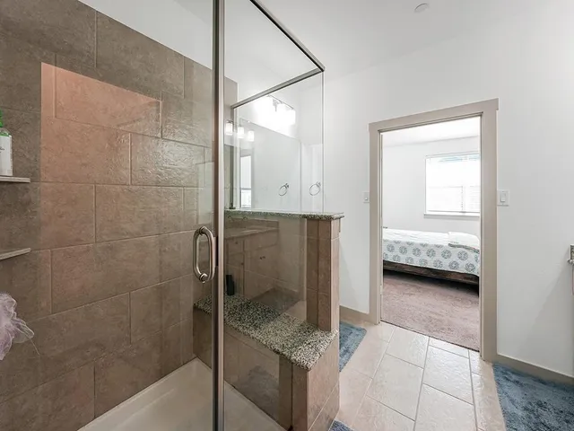 a en suite bathroom with a granite countertop shower