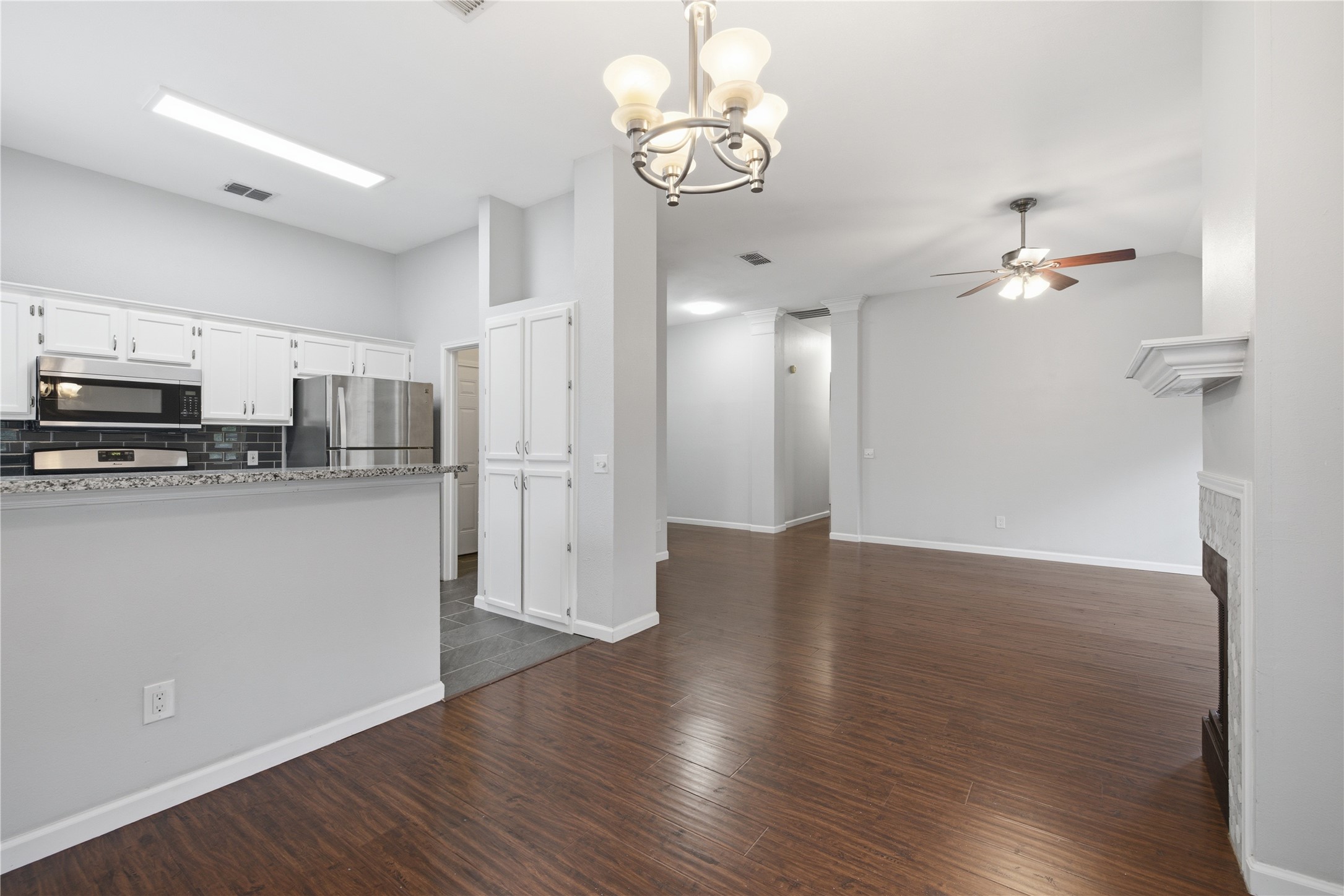 2922 Wickersham Lane Austin, TX 78741 - Photo 9 of 26 a view of a kitchen with wooden floor and a refrigerator