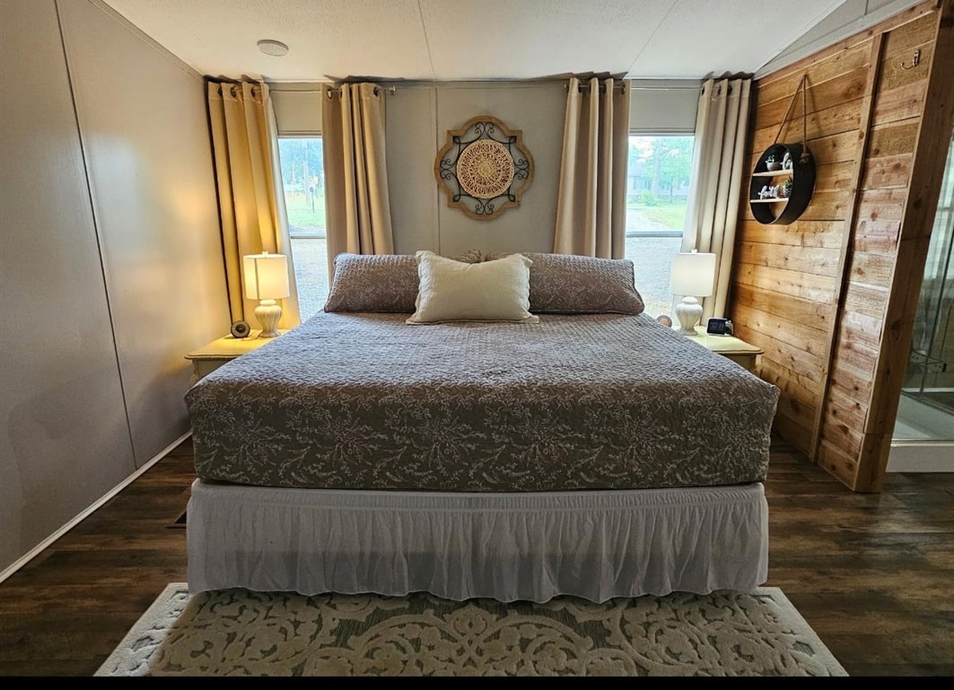 390 Wharf Road Savannah, TN 38372 - Photo 8 of 17 Spacious bedroom featuring wood-finish flooring and multiple windows