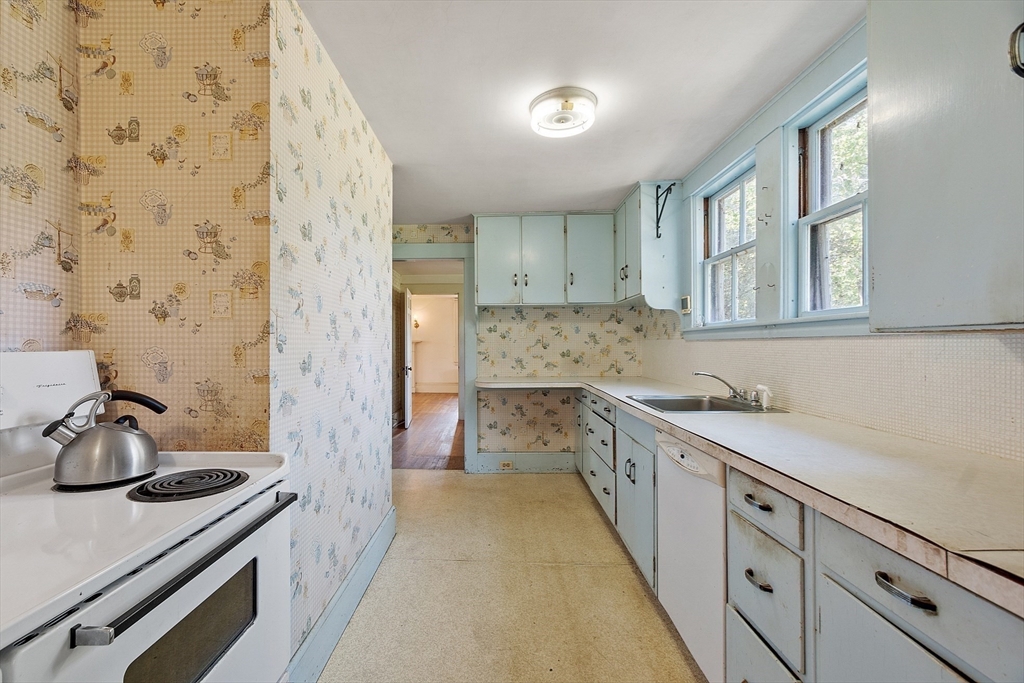 129 Oak Hill Road Harvard, MA 01451 - Photo 11 of 24 a kitchen with a sink stove and cabinets