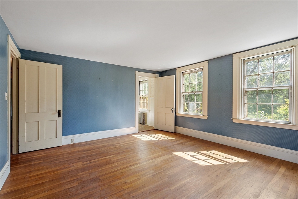 129 Oak Hill Road Harvard, MA 01451 - Photo 18 of 24 a view of an empty room with glass door and wooden floor