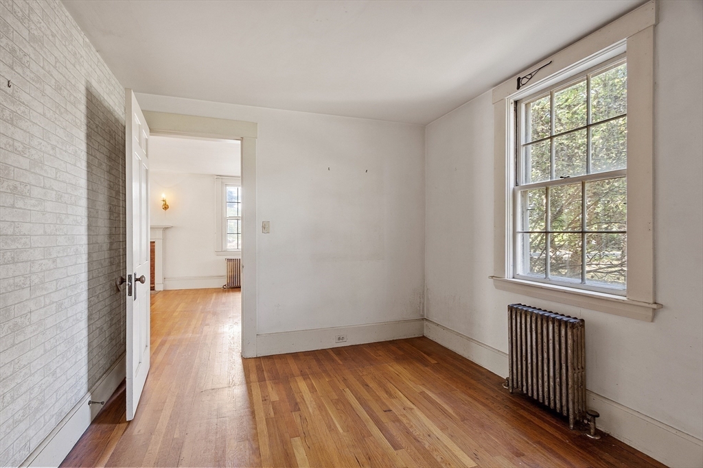 129 Oak Hill Road Harvard, MA 01451 - Photo 10 of 24 an empty room with wooden floor and windows
