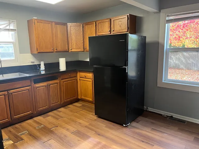 a kitchen with stainless steel appliances granite countertop a refrigerator and a sink