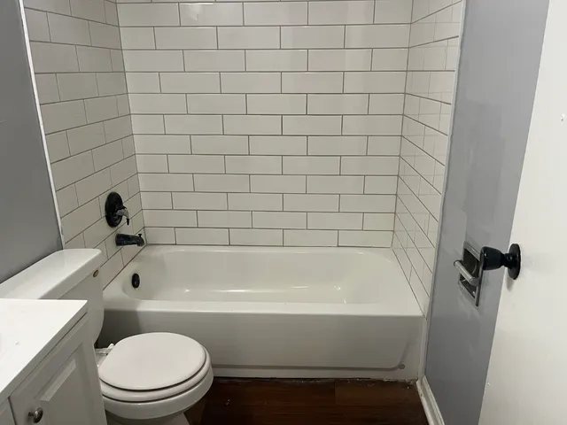a bathroom with a bathtub and a toilet