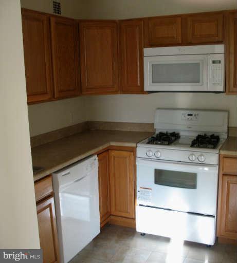 1111 University Boulevard West, Unit 1014 Silver Spring, MD 20902 - Photo 2 of 8 a kitchen with a stove and a microwave