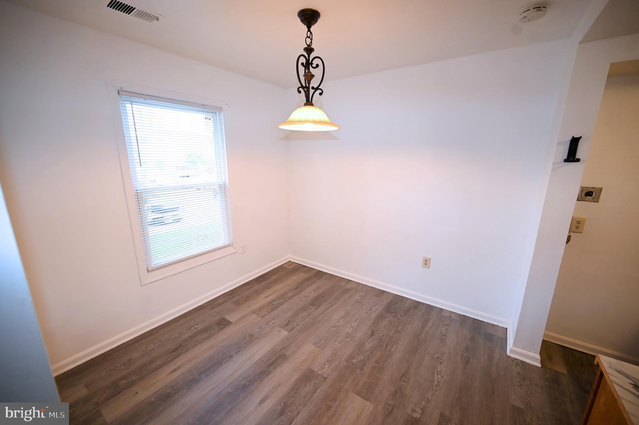 2223 Anvil Lane Temple Hills, MD 20748 - Photo 15 of 30 an empty room with wooden floor and windows