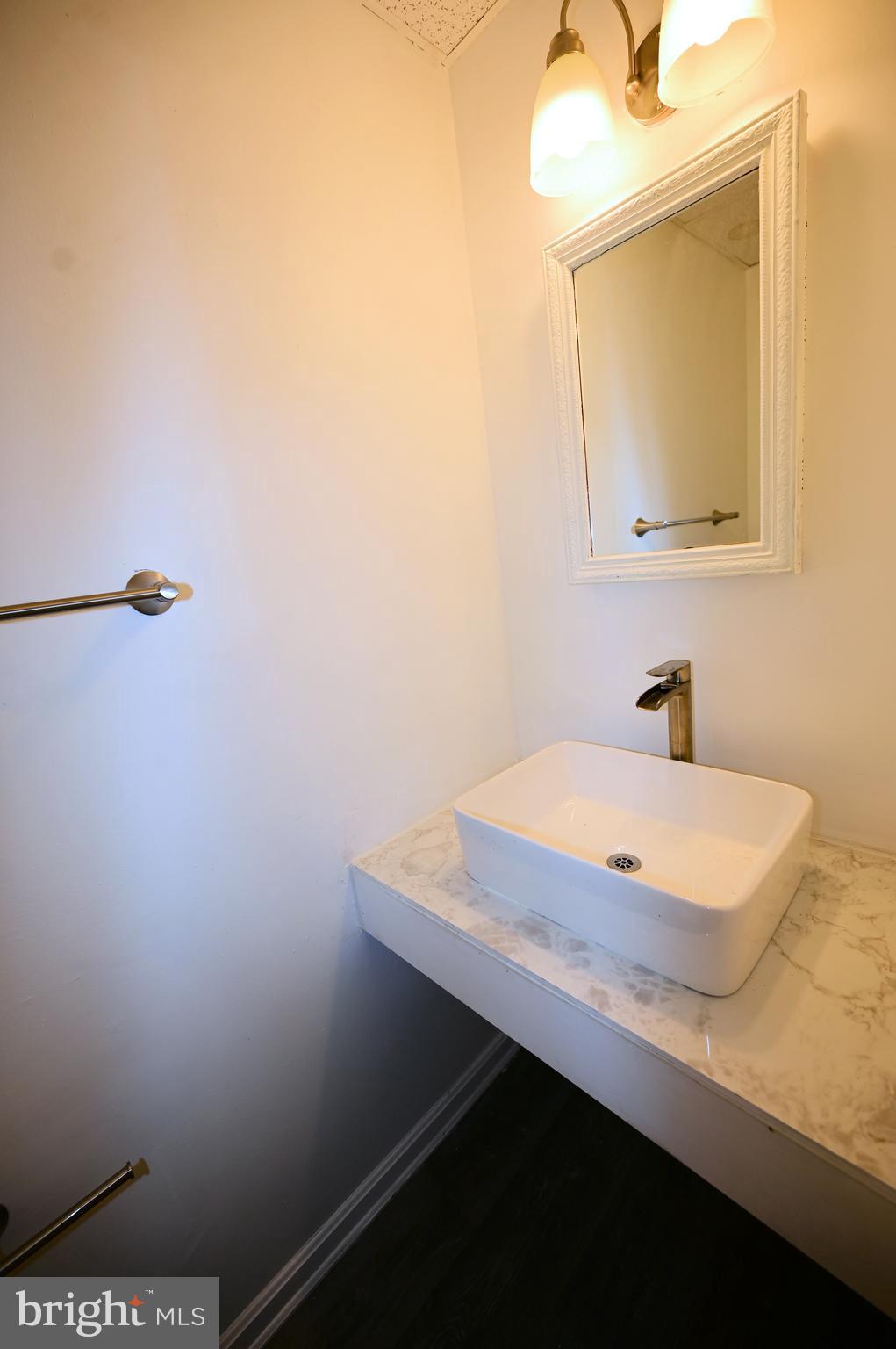 2223 Anvil Lane Temple Hills, MD 20748 - Photo 16 of 30 a bathroom with a sink a mirror and a vanity