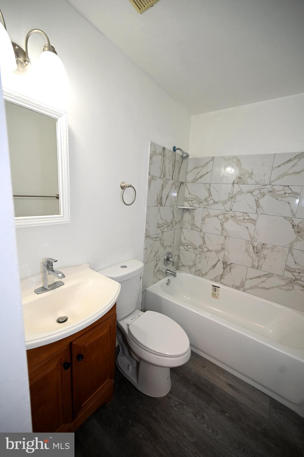 2223 Anvil Lane Temple Hills, MD 20748 - Photo 27 of 30 a bathroom with a sink a toilet and bathtub