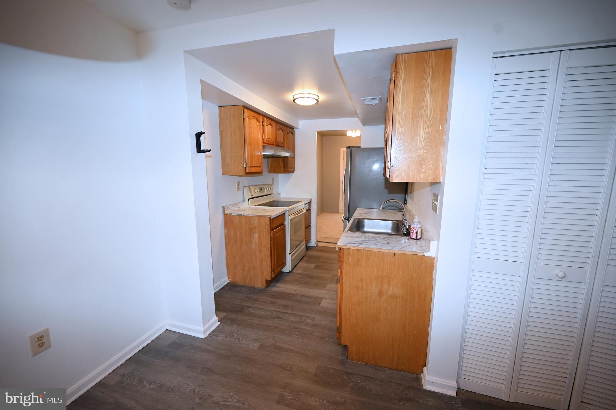 2223 Anvil Lane Temple Hills, MD 20748 - Photo 8 of 30 a view of a kitchen with wooden floor and a sink
