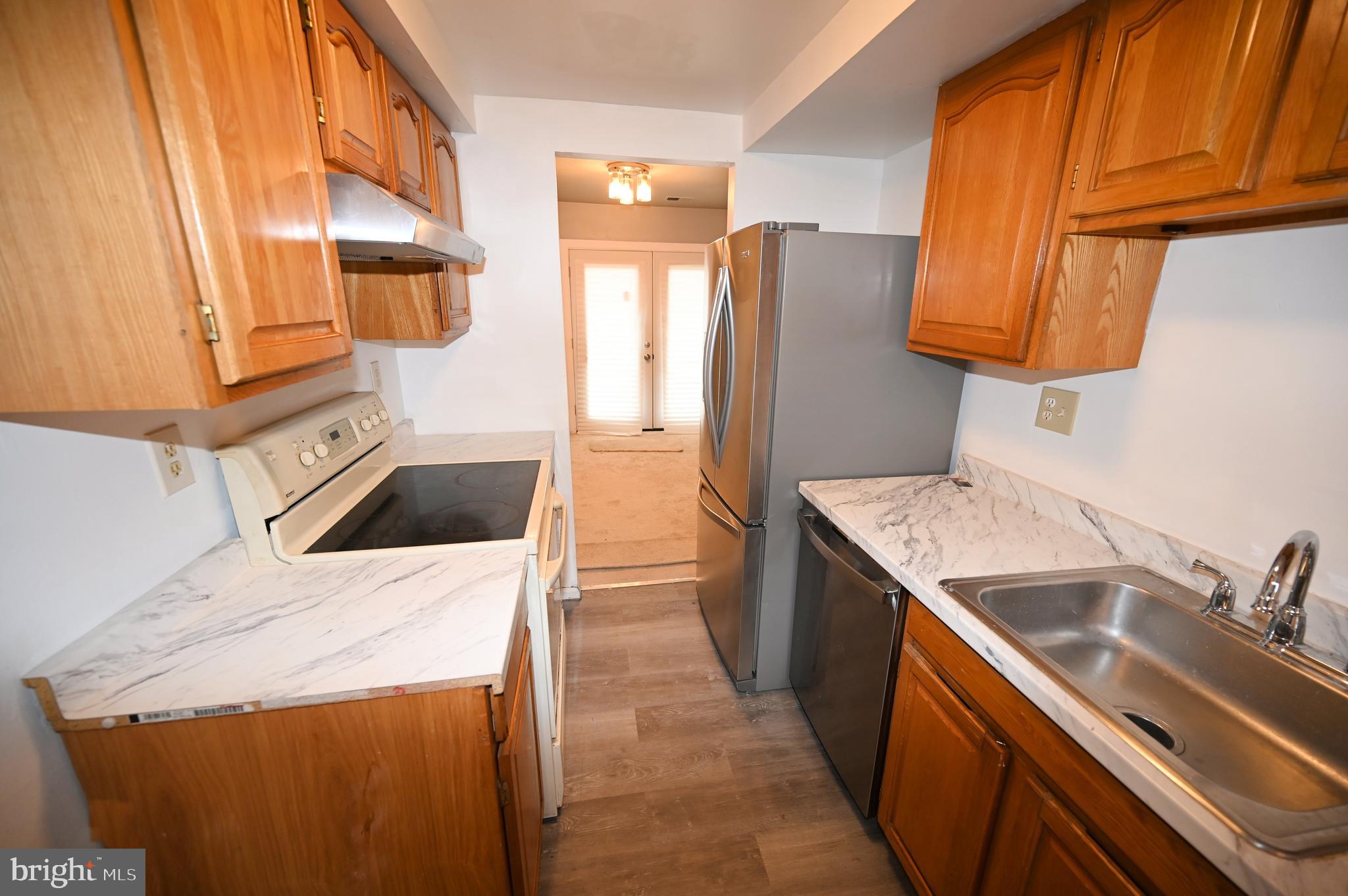 2223 Anvil Lane Temple Hills, MD 20748 - Photo 9 of 30 a kitchen with a sink a stove and a refrigerator