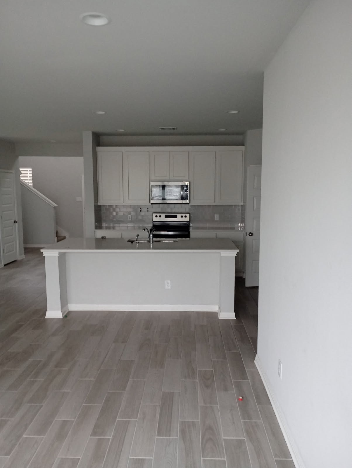 336 Mclintock Road Jarrell, TX 76537 - Photo 14 of 14 a large white kitchen with kitchen island a sink a stove and a refrigerator