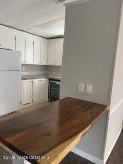 a kitchen with granite countertop a stove and a refrigerator
