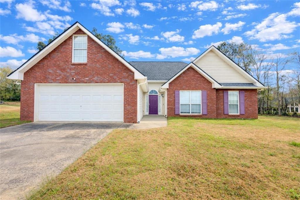 30 Cinnamon Fern Circle Covington, GA 30016 - Photo 1 of 27 a front view of a house with a yard and garage
