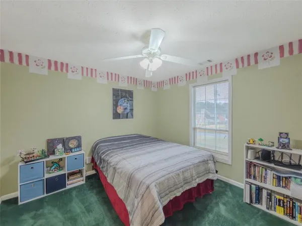 a bedroom with a bed and a book shelf