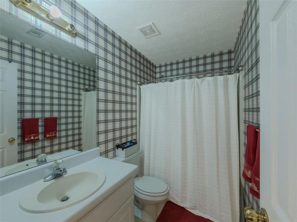 30 Cinnamon Fern Circle Covington, GA 30016 - Photo 16 of 27 a bathroom with a sink and a mirror