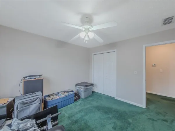 a living room with furniture and a ceiling fan