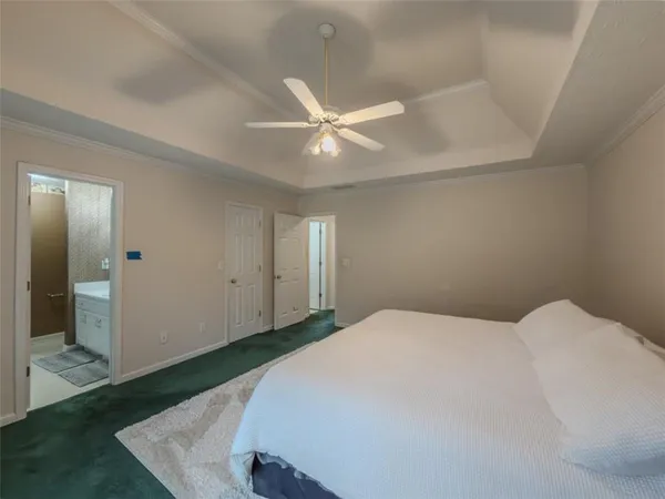 a bedroom with a bed and a ceiling fan
