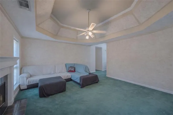 a living room with furniture and a ceiling fan