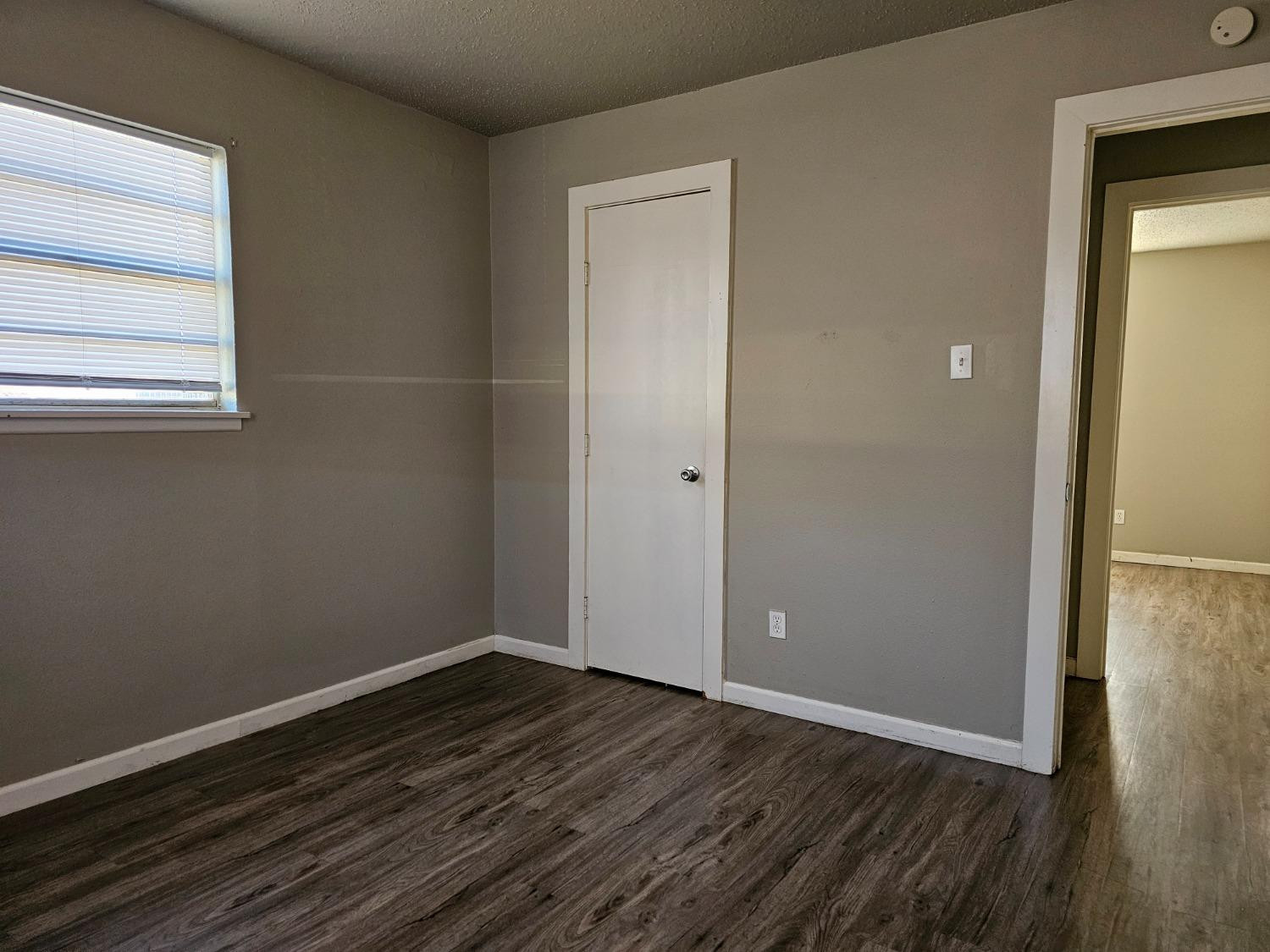 6501 Avenue R, Unit 6503 Lubbock, TX 79412 - Photo 8 of 11 a view of a room with wooden floor and a window