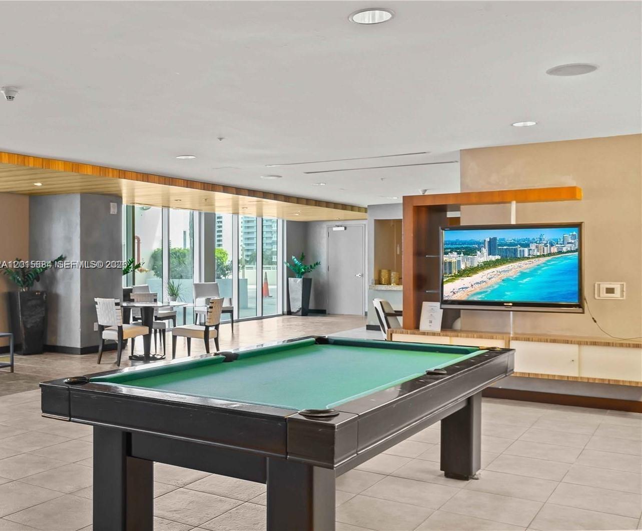 60 Southwest 13th Street, Unit 3609 Miami, FL 33130 - Photo 19 of 24 a room with pool table and windows