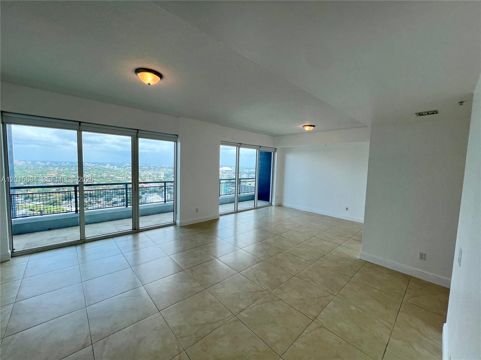 60 Southwest 13th Street, Unit 3609 Miami, FL 33130 - Photo 2 of 24 a view of an empty room and window