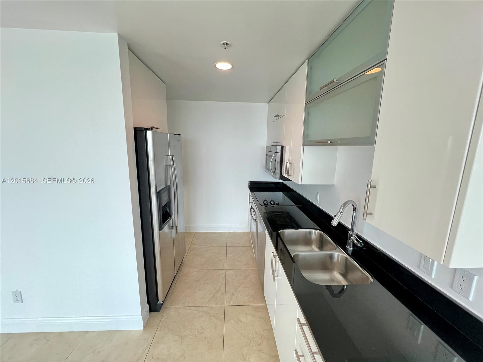 60 Southwest 13th Street, Unit 3609 Miami, FL 33130 - Photo 24 of 24 a kitchen with a refrigerator and a sink