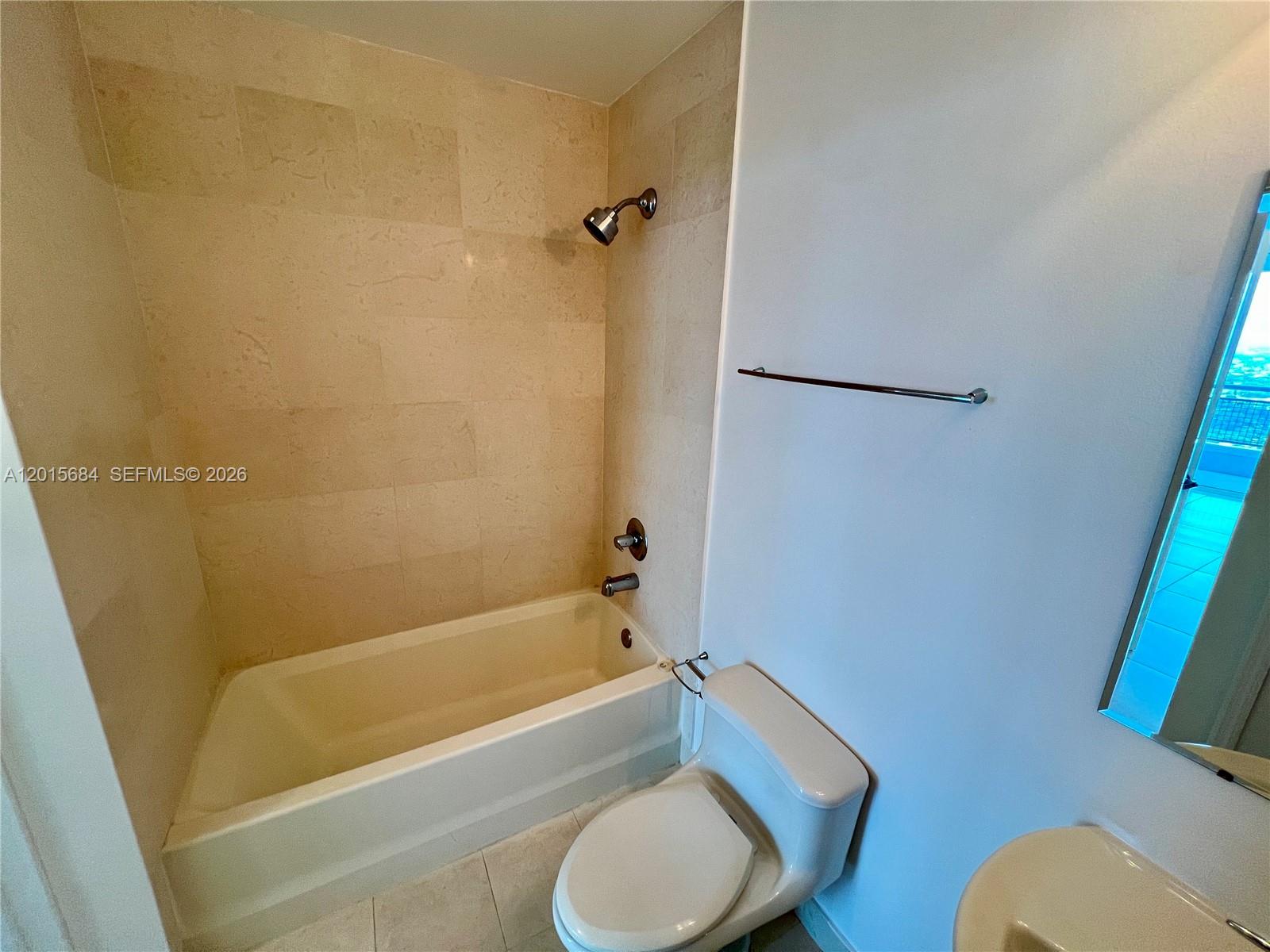 60 Southwest 13th Street, Unit 3609 Miami, FL 33130 - Photo 8 of 24 a bathroom with a tub and a shower