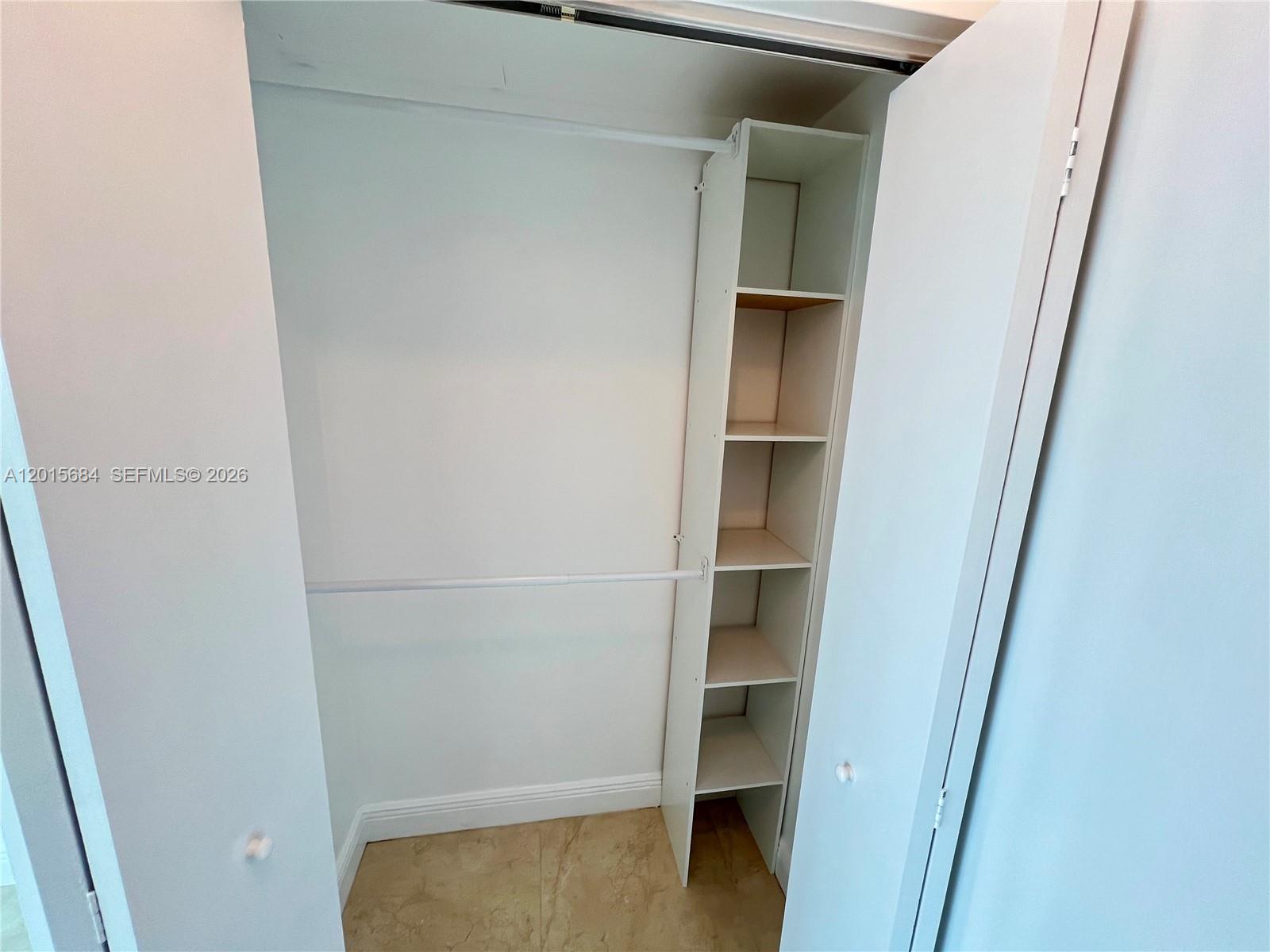 60 Southwest 13th Street, Unit 3609 Miami, FL 33130 - Photo 9 of 24 a view of walk in closet with empty racks